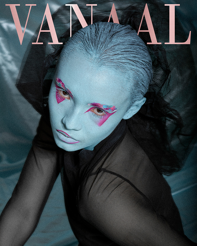 Black and white photograph of a man with a tunic on his head, praying with his hands on his face.