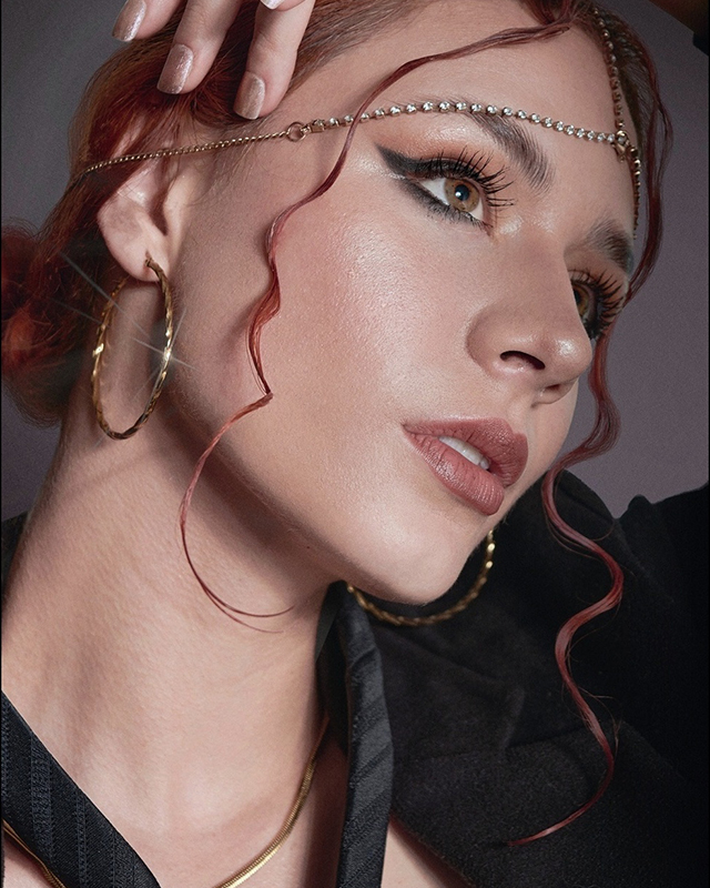 Black and white photograph of praying man wearing a tunic, looking towards the sky.