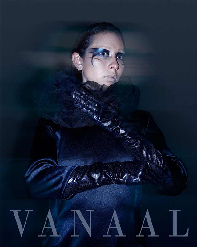 Black and white photograph of man with tunic on his face and a chain in his hand.