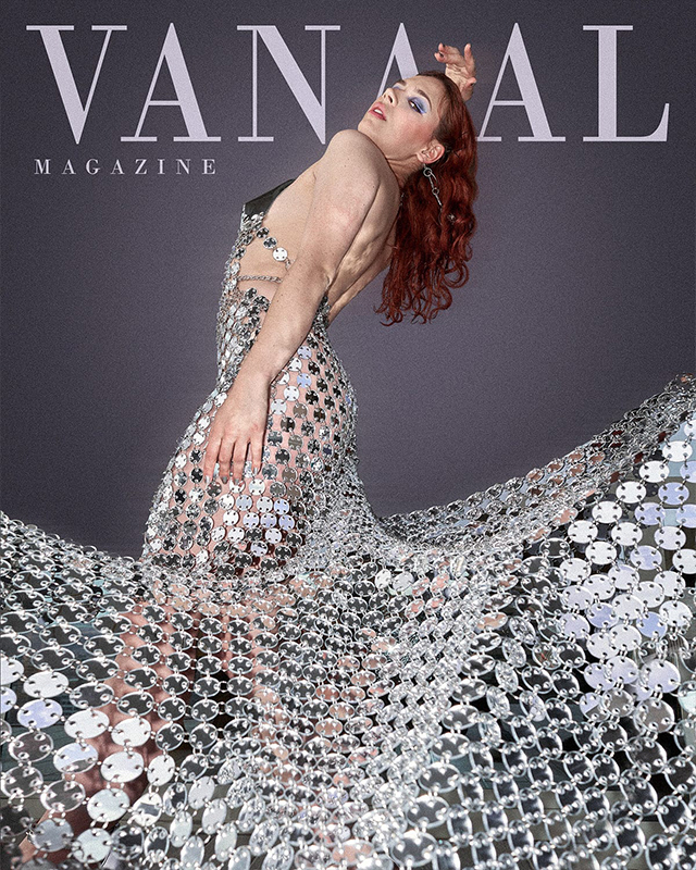 Black and white photograph of a nun covering her face with one hand and an open bible in the other hand.